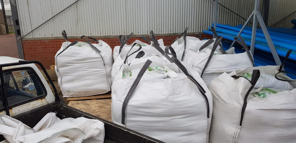Large white sacks of donated horse food loaded on a trailer